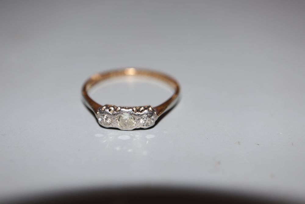 A 1930s 18ct and plat three stone diamond ring, size M, gross 1.7 grams.